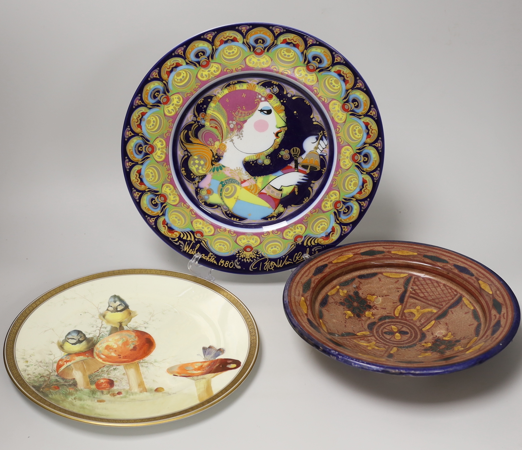A Cauldon plate painted with blue tits on toadstools and a butterfly on another, signed R. Barratt, Derby, made for Burley & Co. Chicago, a Rosenthal limited edition plate Weihnachtsteller 1980, and an art pottery dish